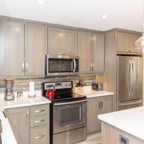 Chef-ready kitchen with stainless steel appliances, quartz countertops, center island and pendant lighting